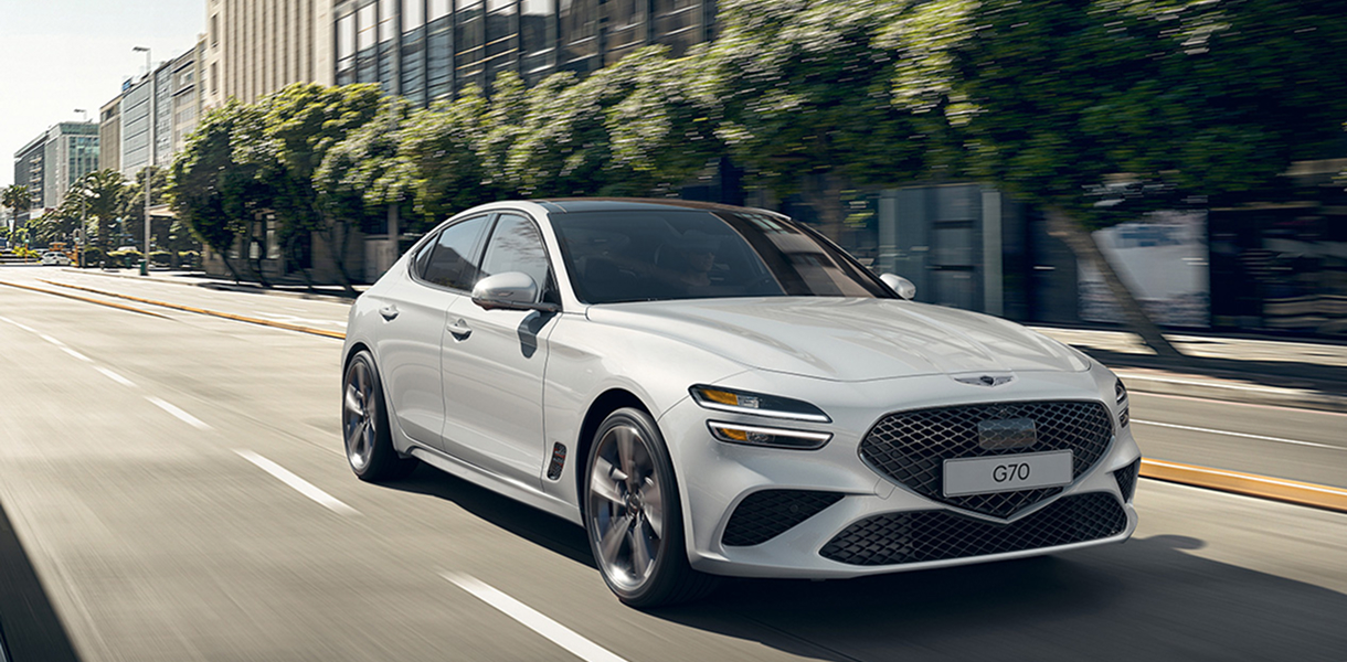 White G70 driving on a city street