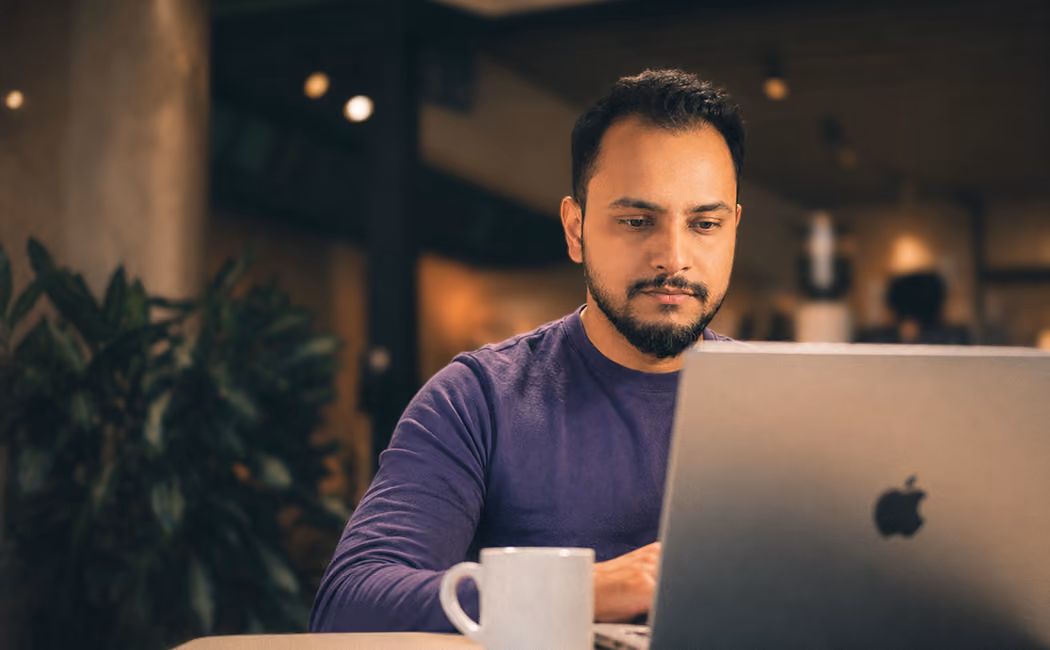 Designer working on a laptop in a cafe