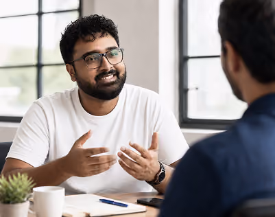Designer discussing a project with a client at a desk