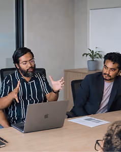 Design Monks team members in a meeting at a laptop