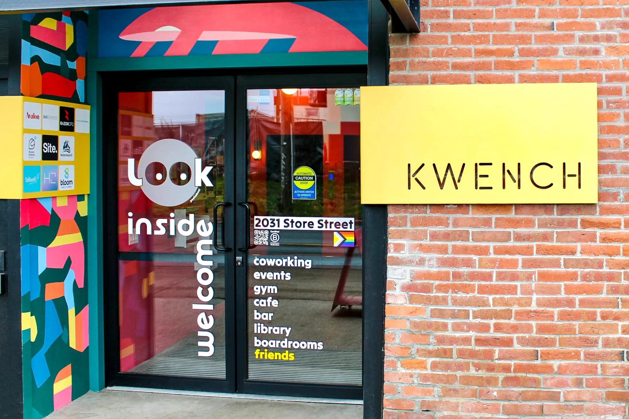 KWENCH front door, with mural, logo and members signage