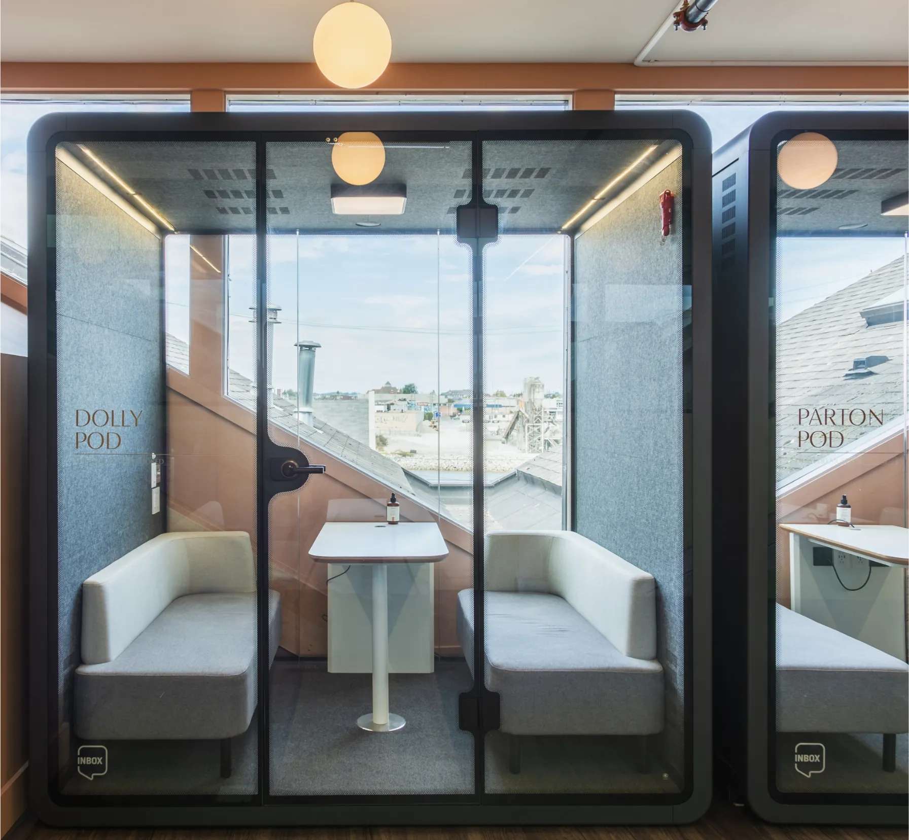 KWENCH Dolly Pods with table, booths, felt walls, and glass doors.