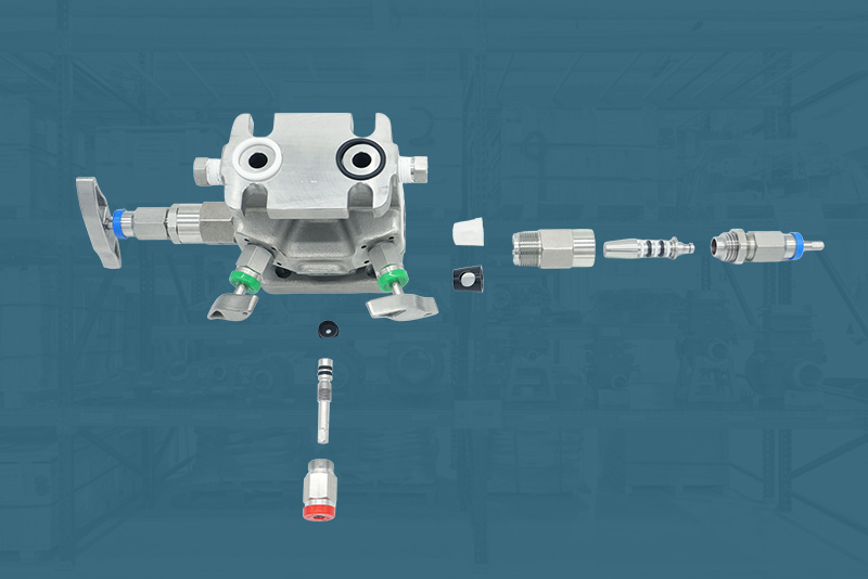 Image of an isolated Seat & Seal Steam Measurement Manifold on a teal background with factory environment.