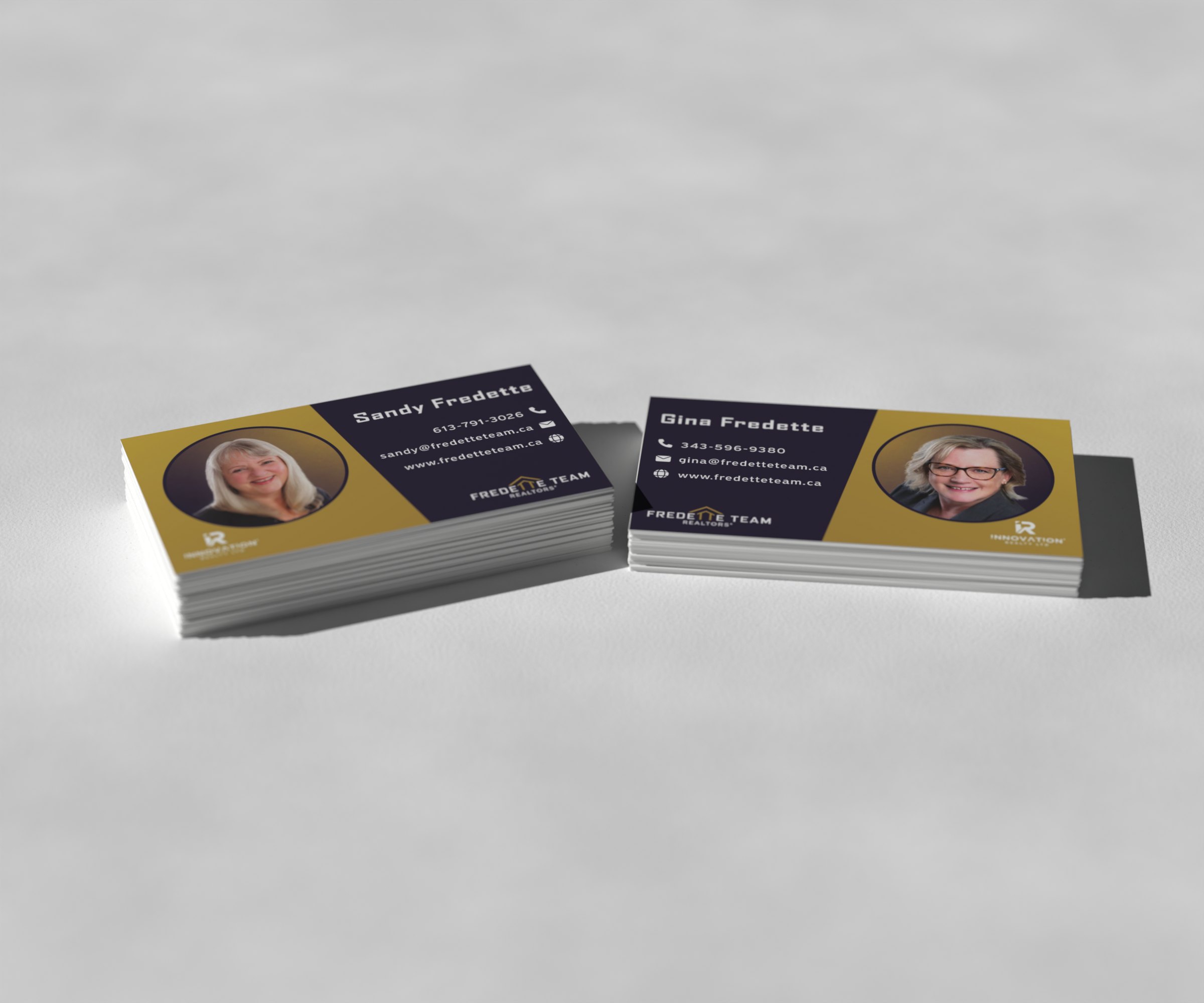 Sandy and Gina Fredette business cards stacked on concrete