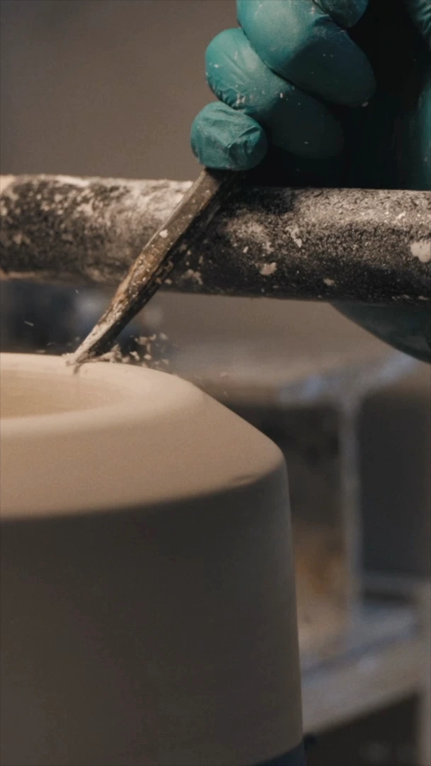 Man shaping ceramic with tools
