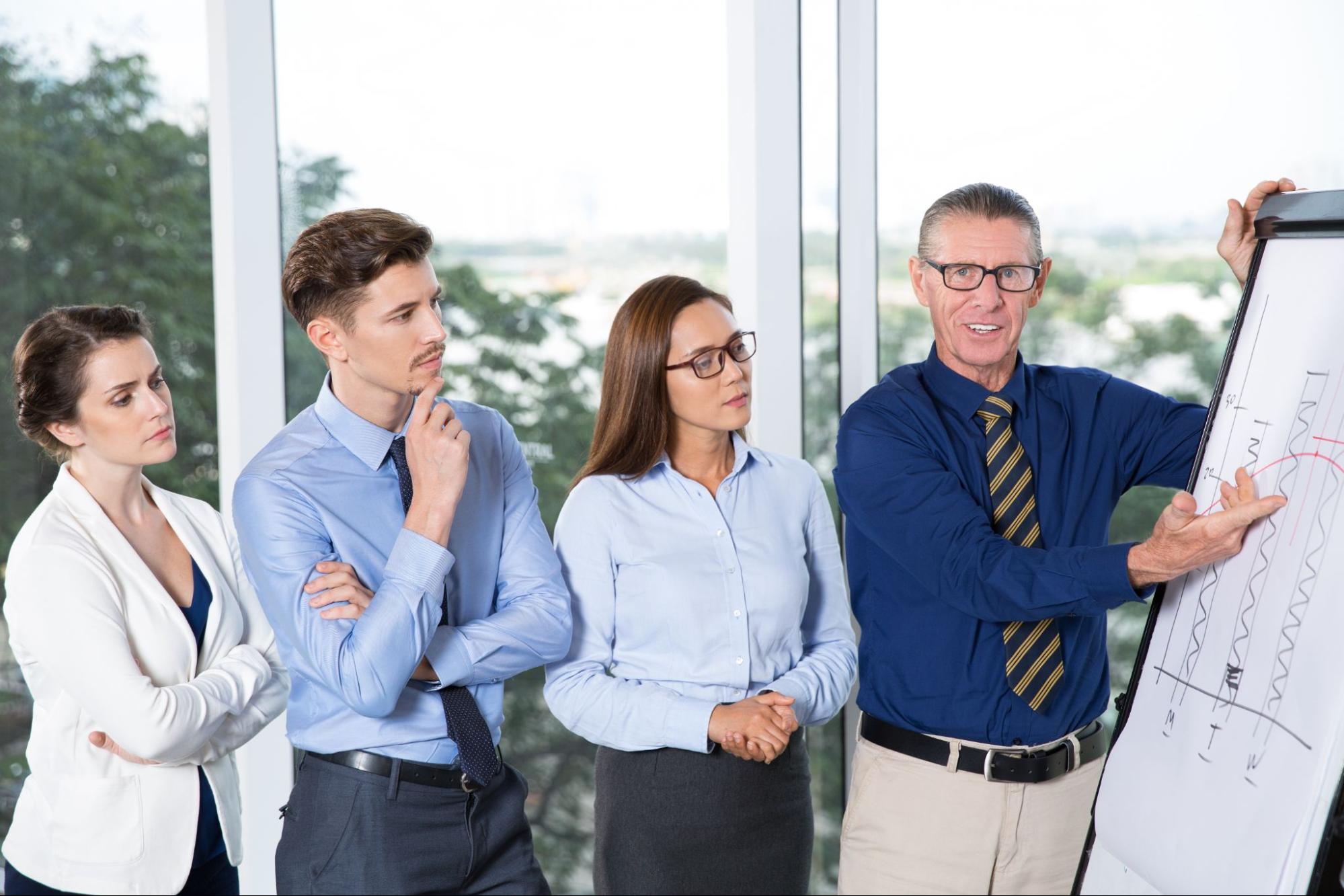 A businessman presenting a chart to his colleagues.