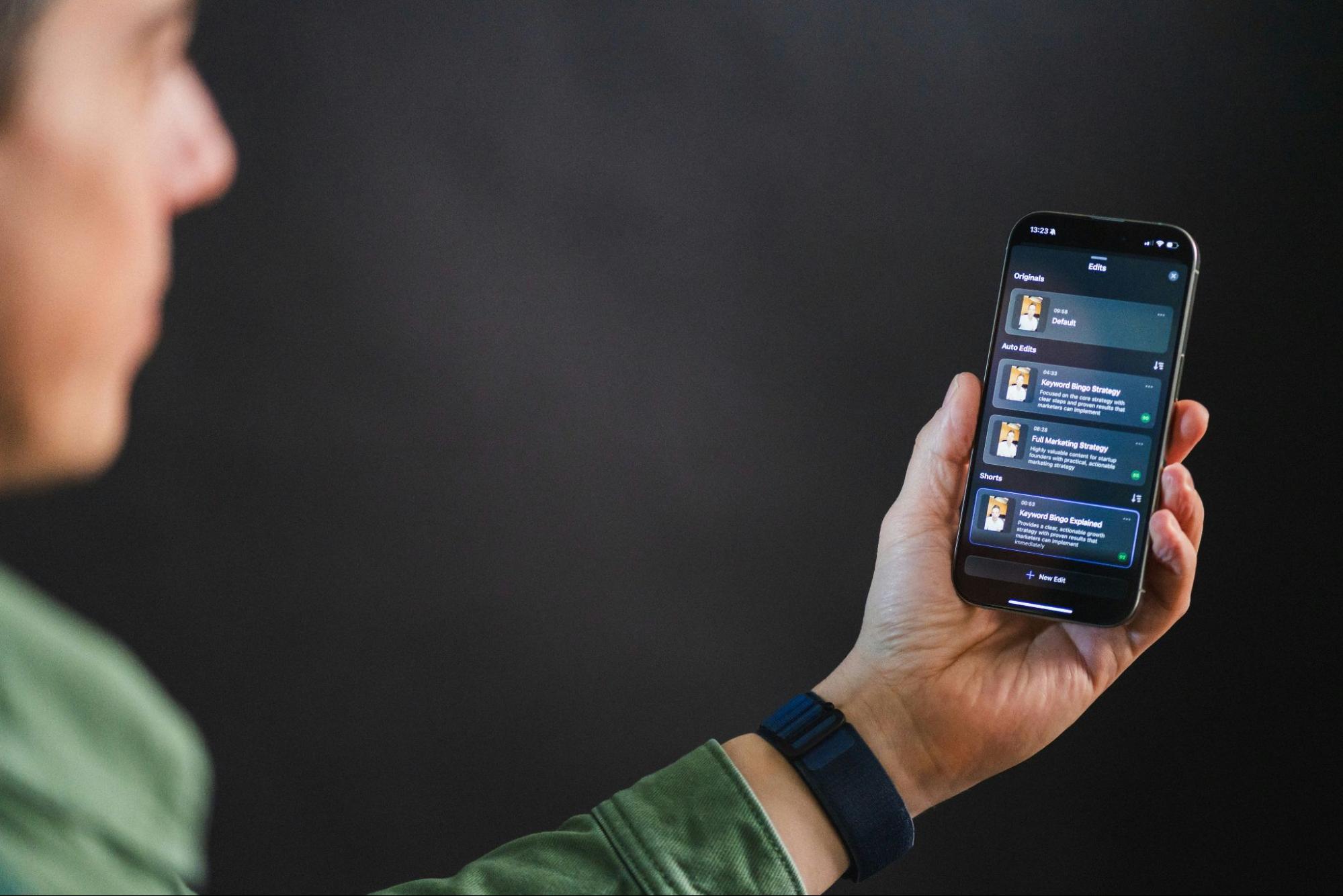 A person using an AI Auto Edit app on a phone.