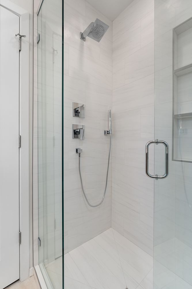 Small bathroom in Bothell converted from tub to walk-in shower with light tile