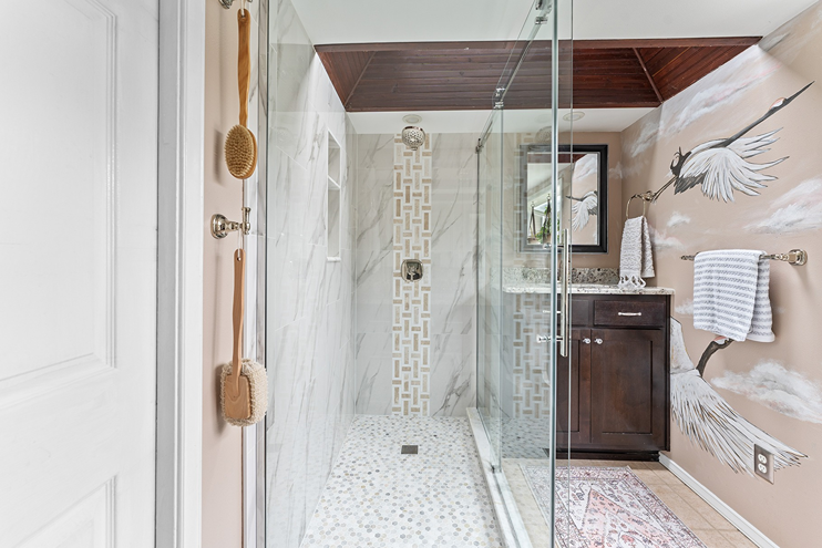Walk-in shower near a vanity sink with furniture-style cabinetry in Bothell