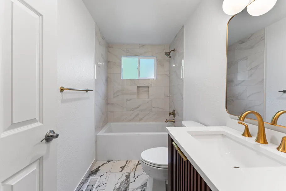 Freestanding tub with surround tile wall and showerhead in Bothell
