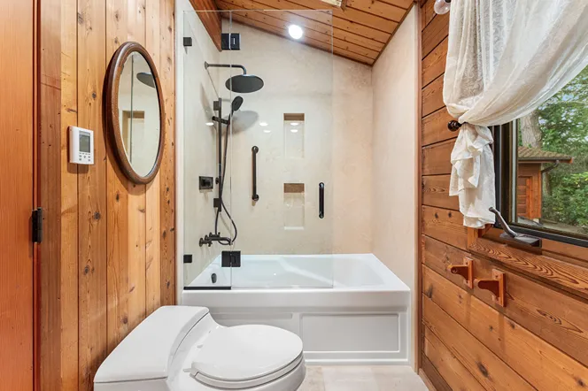 Comfort-height toilet next to a freestanding tub and shower in a remote Bothell home