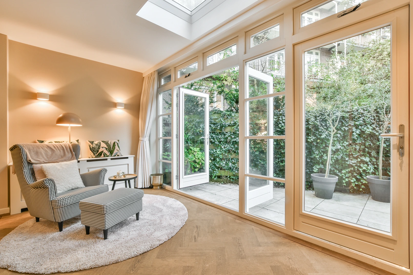 A lounge chair in a sunroom facing a garden in Bothell