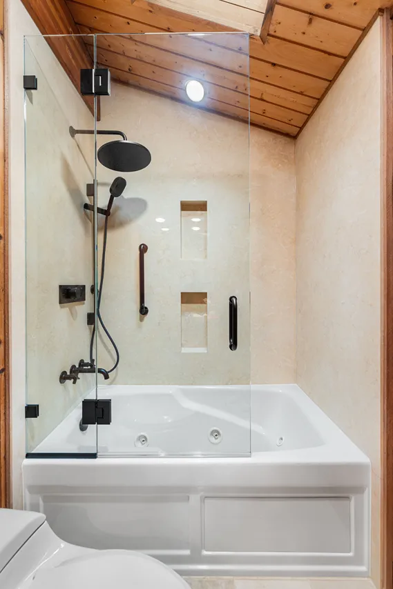 A newly remodeled shower with glass enclosure walk-in tub in Bothell