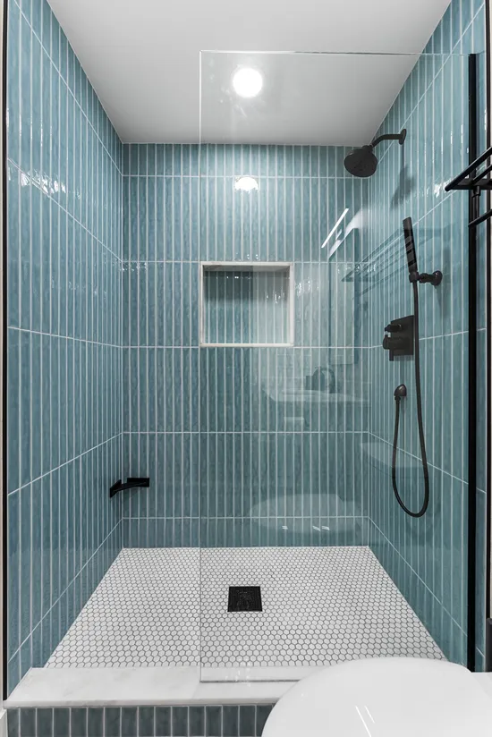 Walk-in shower with blue vertical stacked grid wall tiles in Bothell