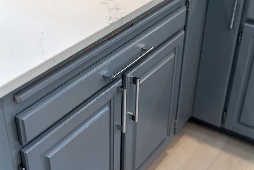 Close-up of slate blue painted lower cabinet doors and drawers