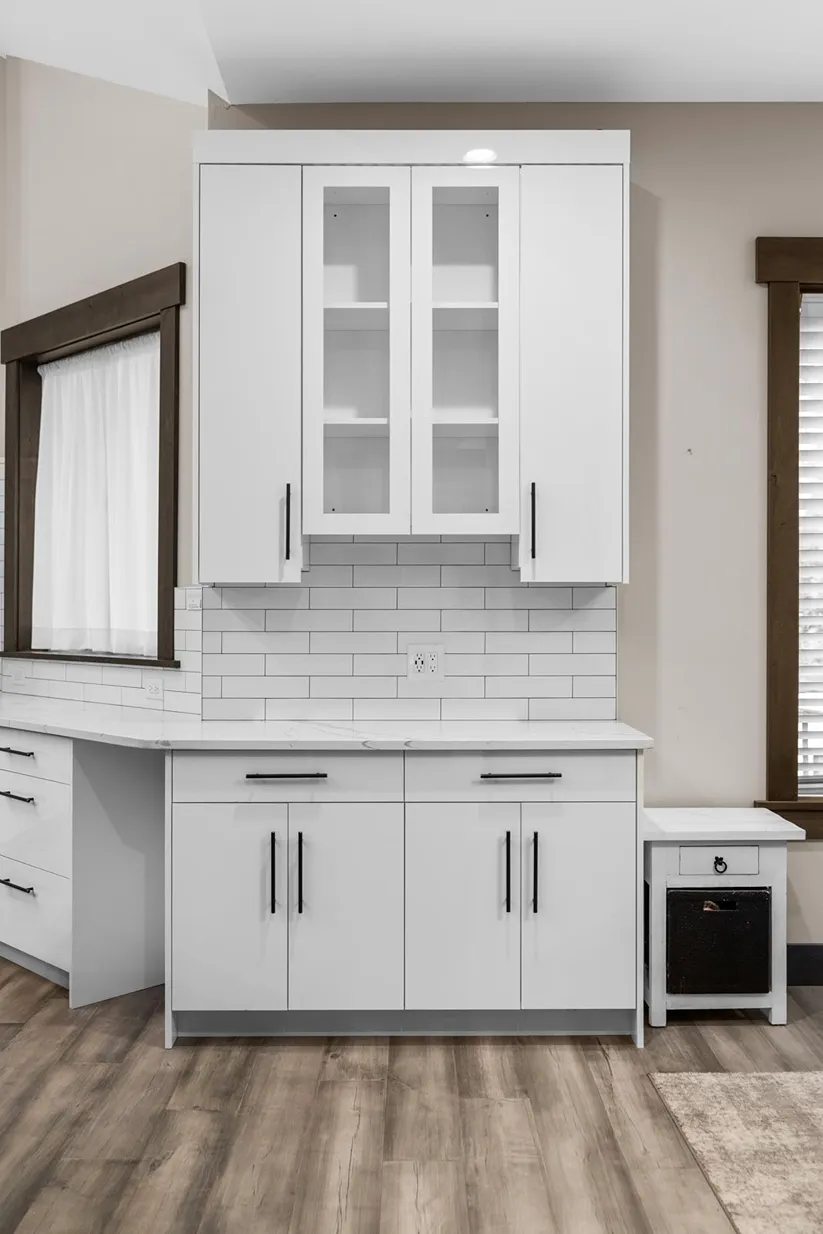 Crisp white painted cabinet doors and glass display doors with black handles