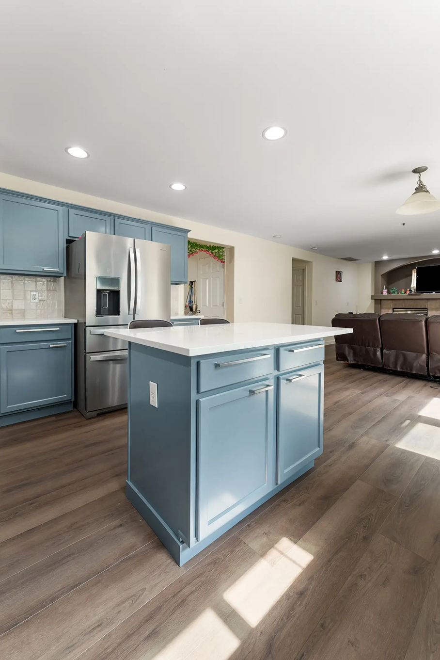 Blue kitchen island topped with clean white quartz countertops in Bothell