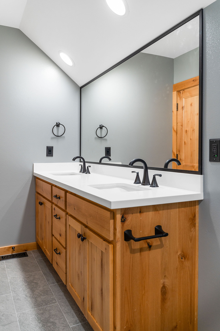 White solid-surface countertop with short backsplash and dual under-mount sinks