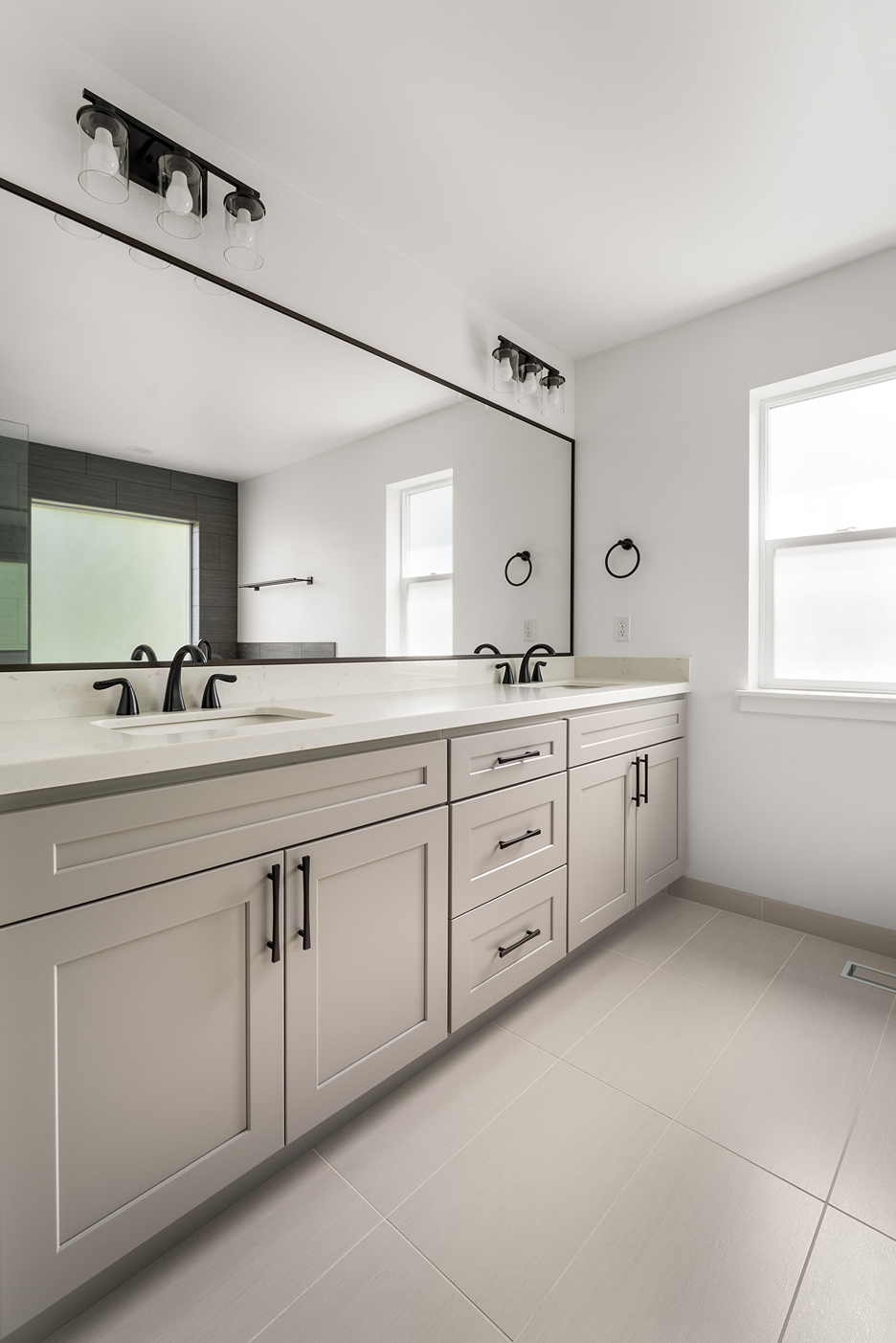 White quartz double vanity countertop with matching low splash guard