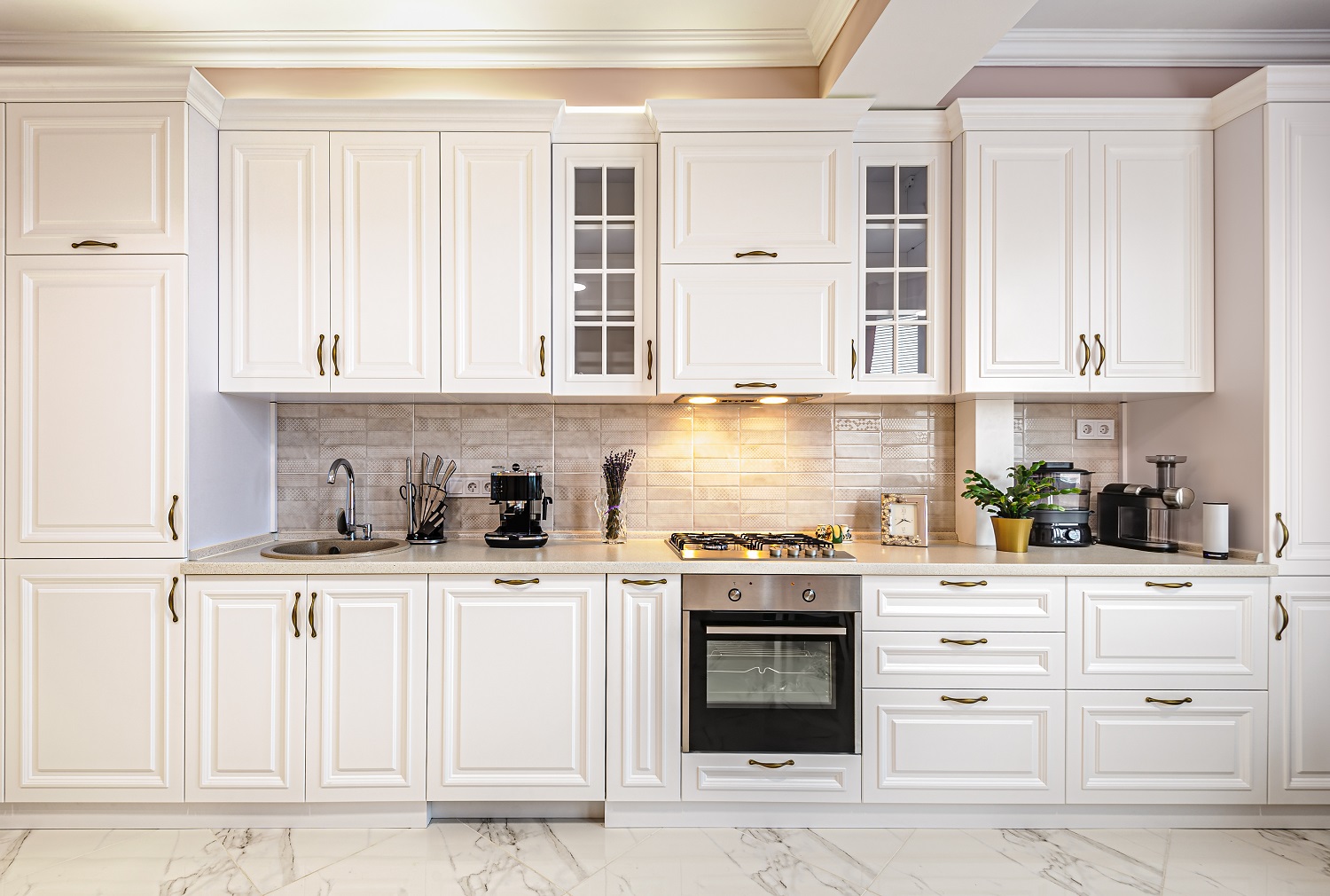 Bright kitchen with stylish minimalist customized white cabinets and gas range 