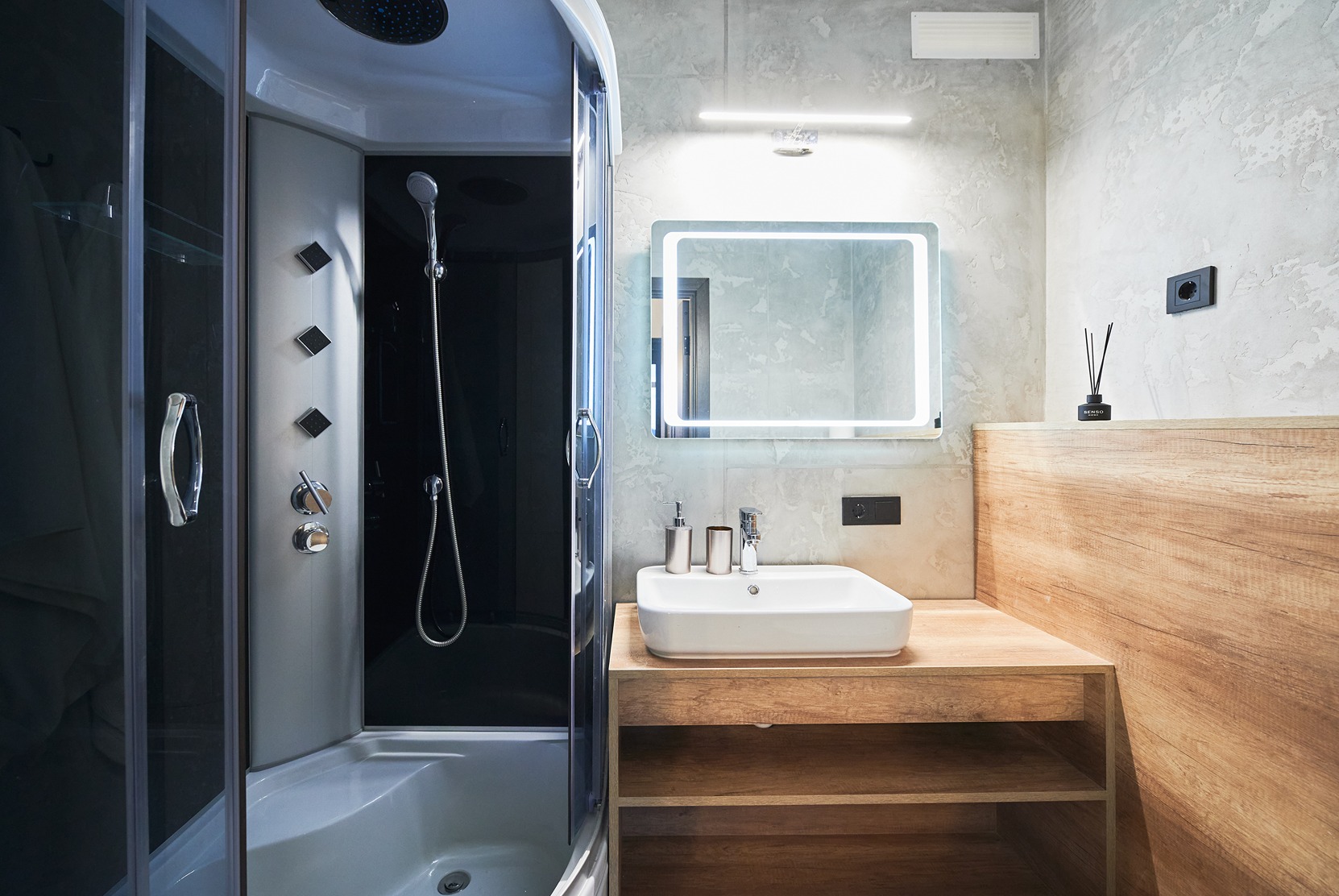 A custom bathroom remodel in Bothell with shower enclosure and vanity mirror