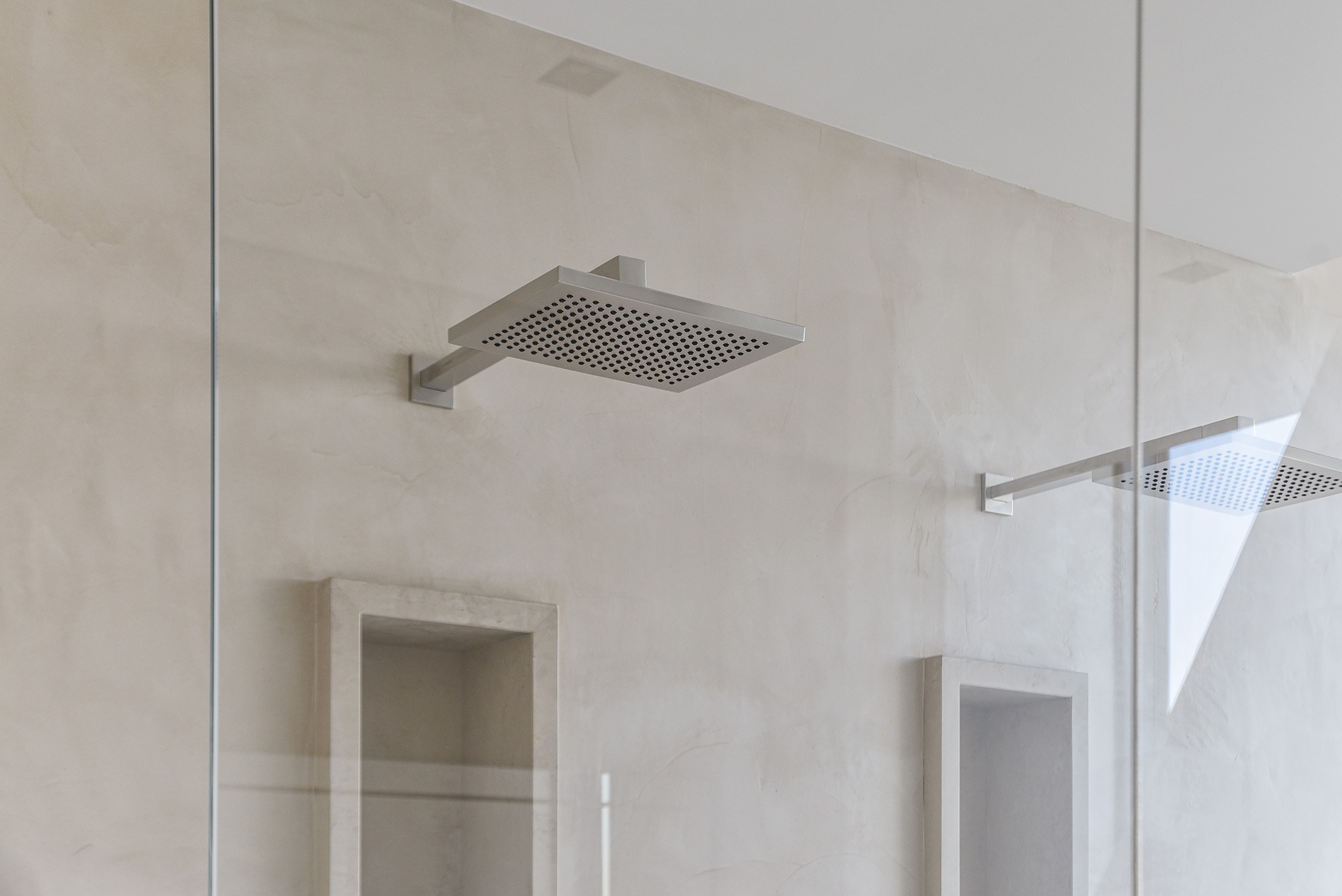 A frameless shower enclosure with a shower head in a Bothell home