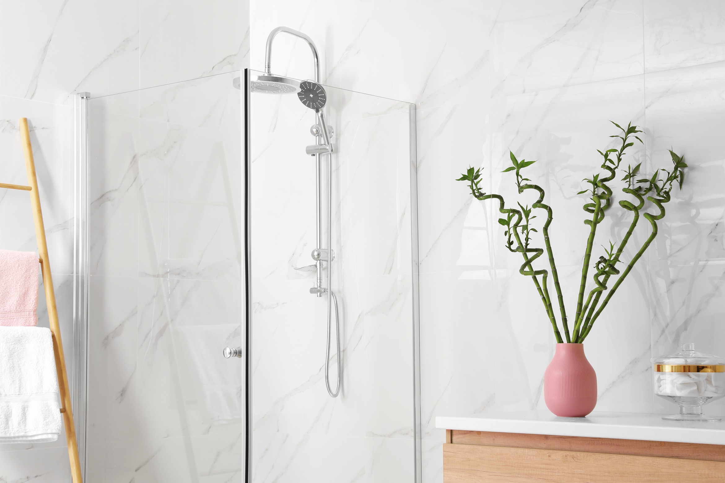 Shower stall in a bathroom in Seattle with white tiled walls