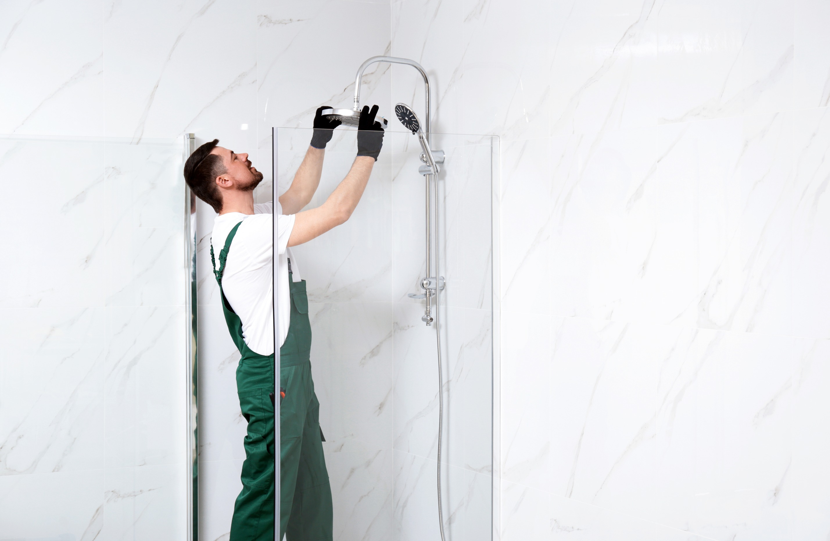 Bathroom remodel contractor in Seattle installing showerhead