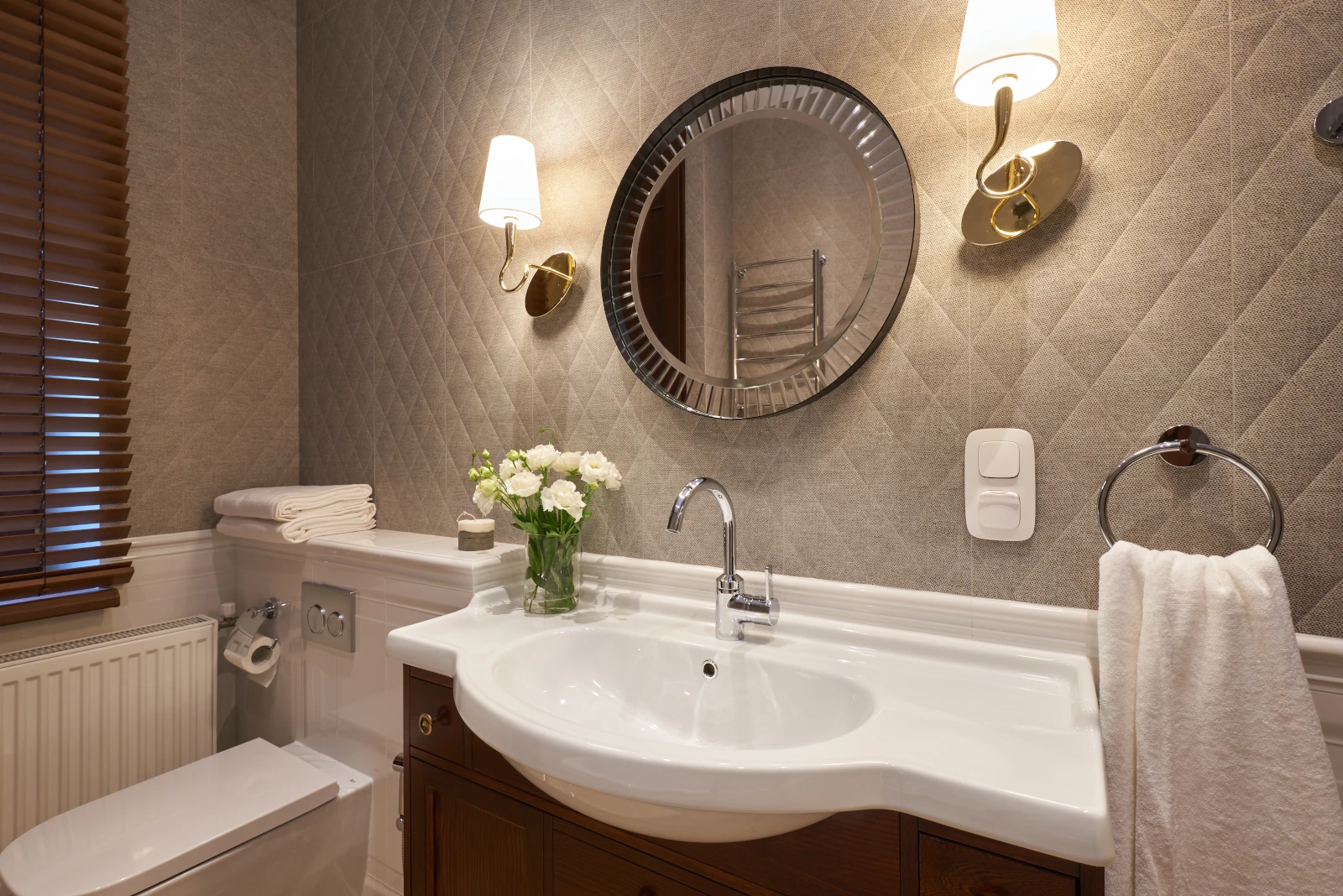 Half bath lighting fixtures in a remodeled Bothell powder room with wall sconces 