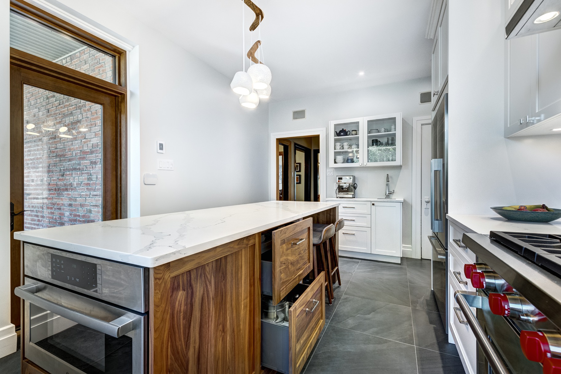 Bothell kitchen remodel featuring a mixed material kitchen island with walnut cabinetry and white quartz countertop