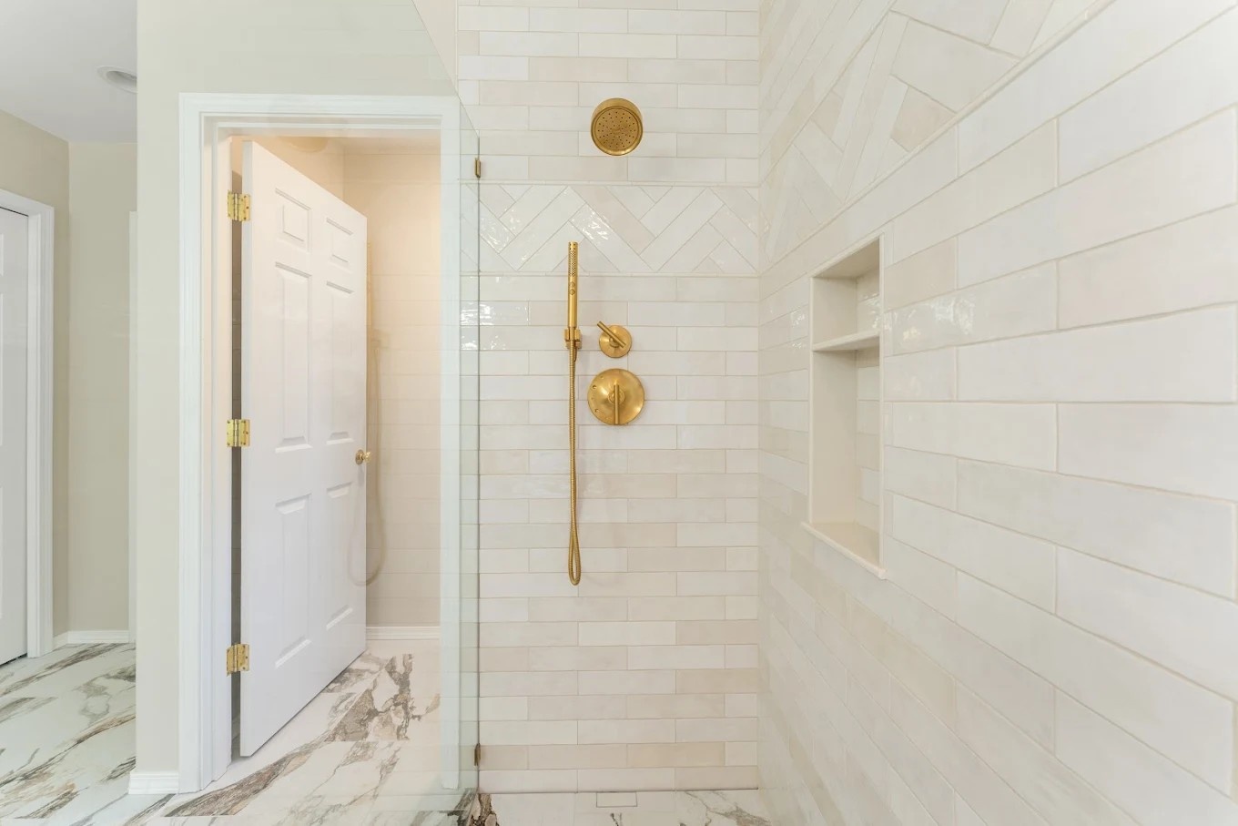 Tiled bathroom walls with frameless glass walls in a Bothell home