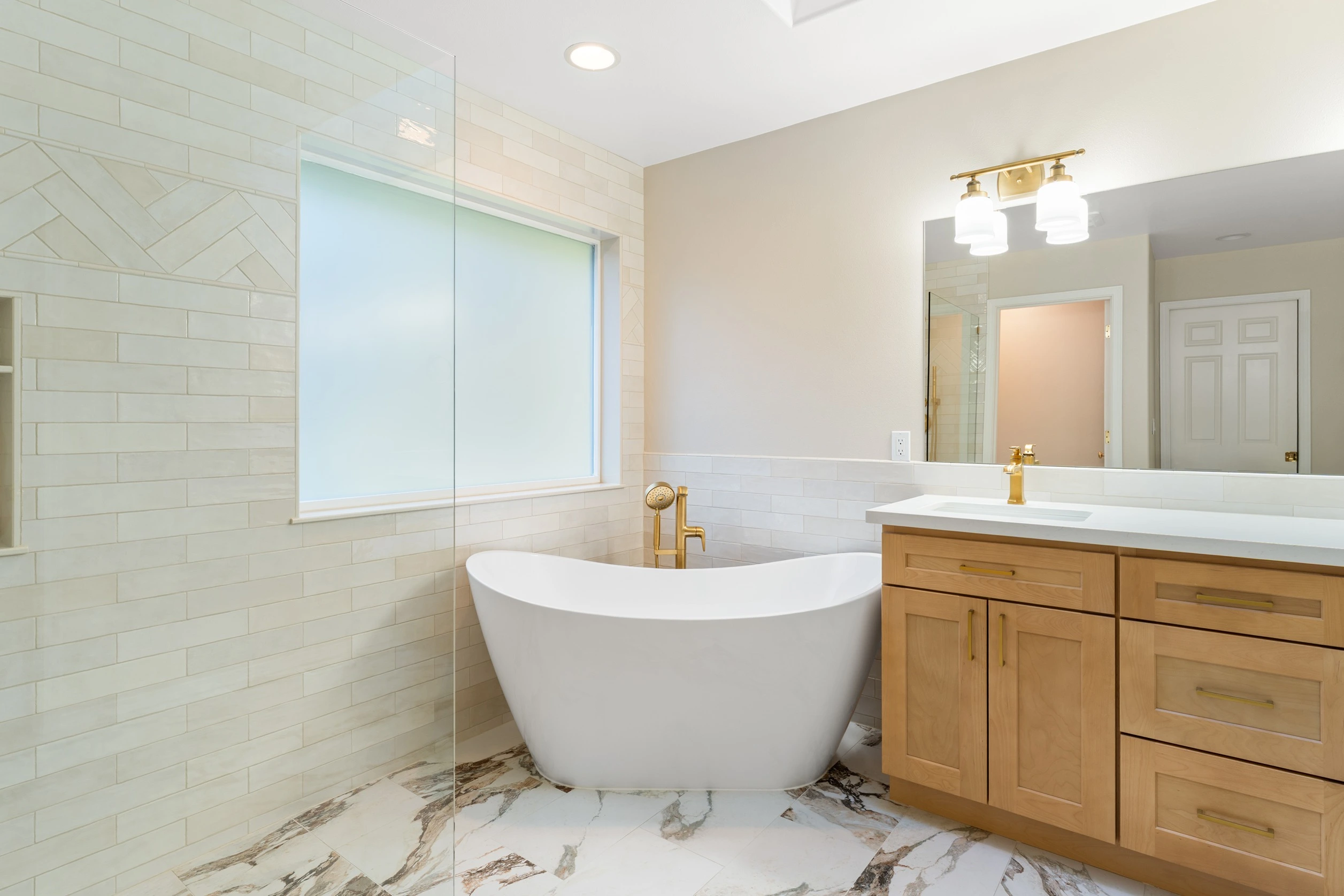 Freshly remodeled bathroom with modern tile and glass shower