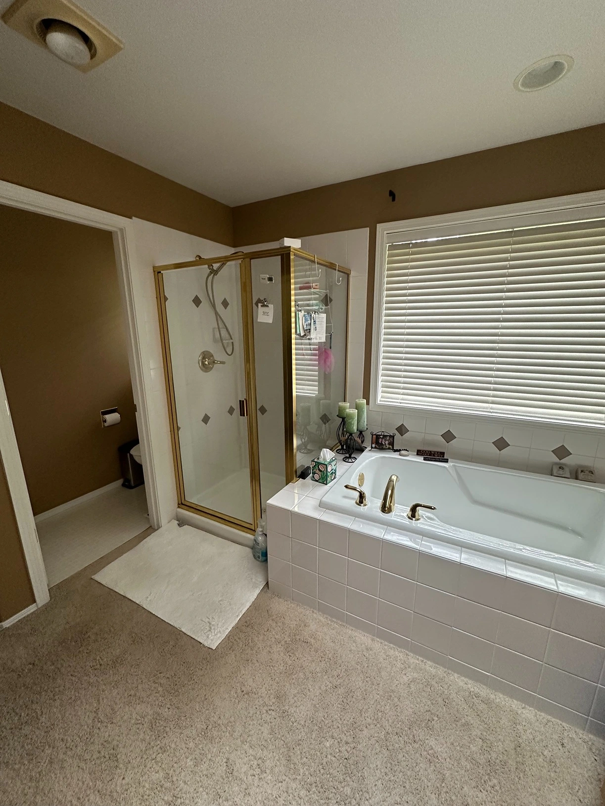 Outdated bathroom with worn tile and dated vanity