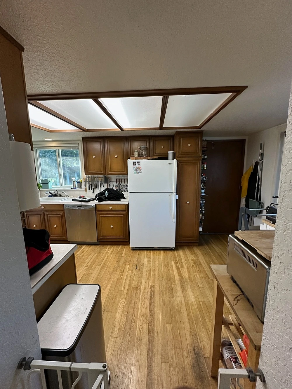 Outdated kitchen with dark cabinets and limited counter space