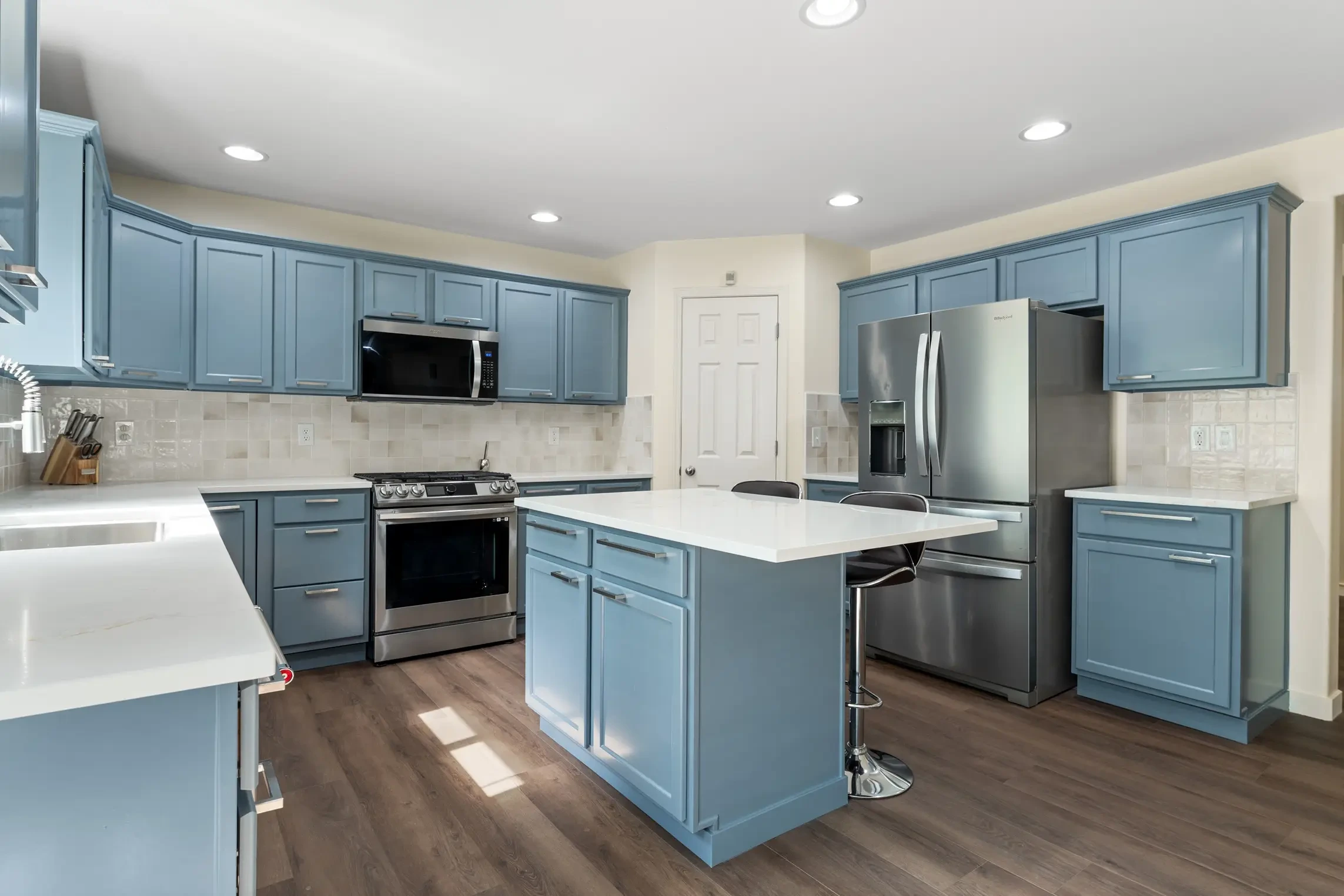 Spacious remodeled kitchen with quartz countertops and island