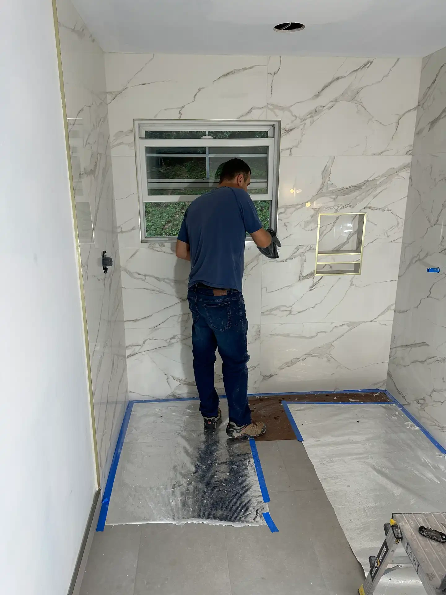 Bathroom renovation in progress with exposed plumbing and tile