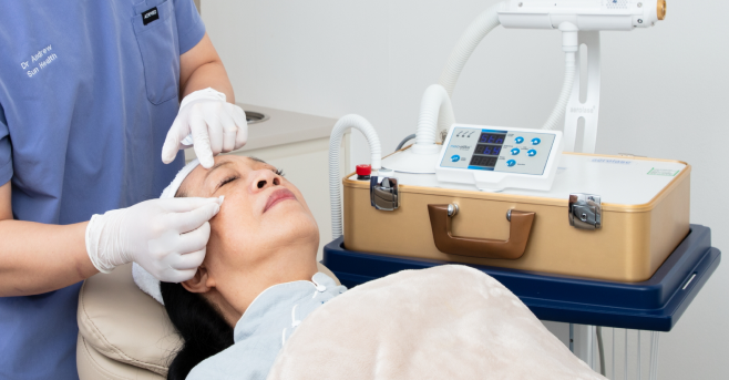 An Asian woman going through facial treatment.