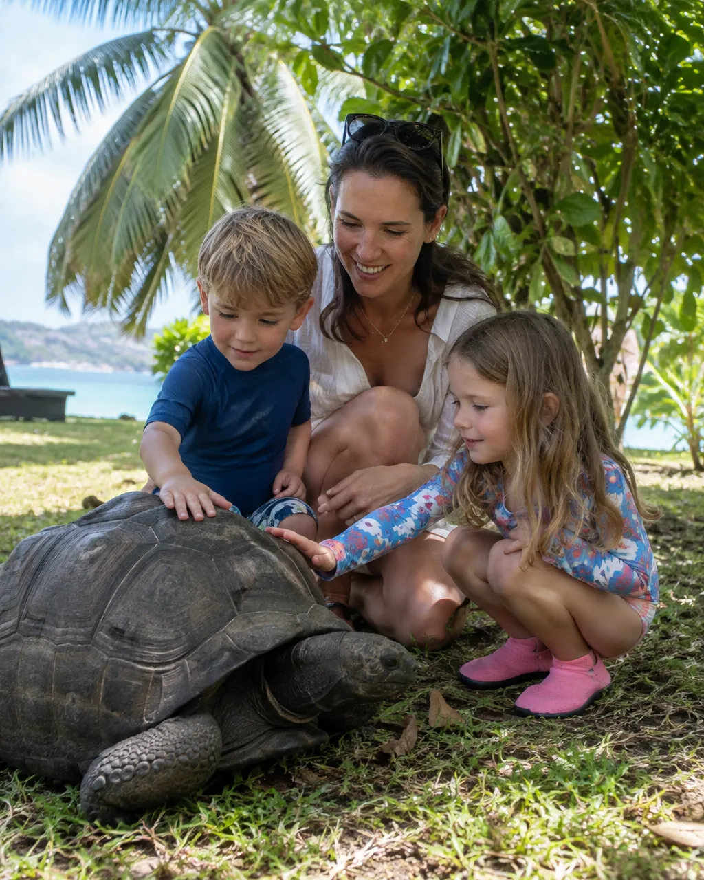 Kinderen aaien een reuzenschildpad op de Seychellen