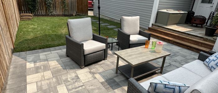Calgary outdoor entertainment space with paving stone patio and fire pit at dusk