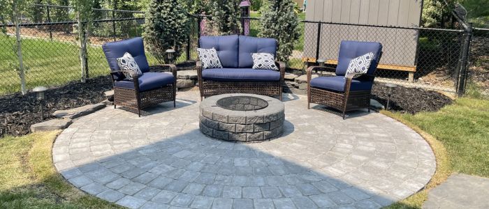 Natural fire pit with seating area in Calgary outdoor entertainment space