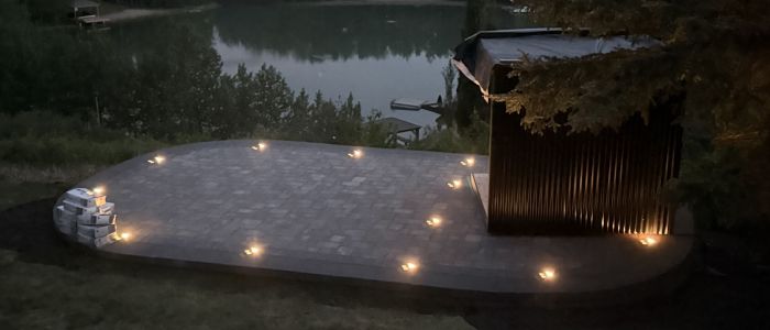 Calgary outdoor entertainment space with ambient path lighting at night