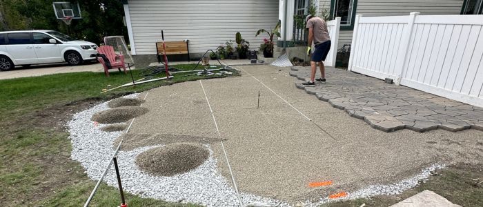 Western Elements Landscaping crew installing a paving stone patio in Calgary