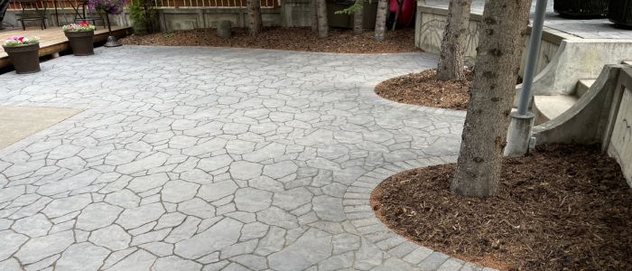 Natural stone landscaping Calgary backyard retaining wall flagstone patio
