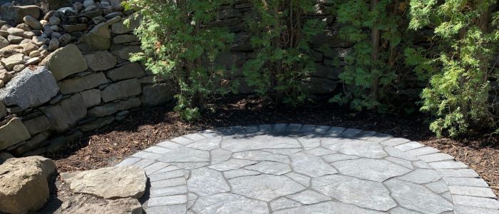 Boulder retaining wall natural stone landscaping Calgary backyard