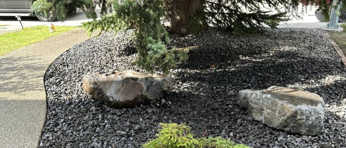Moss rock natural stone feature Calgary landscaping backyard