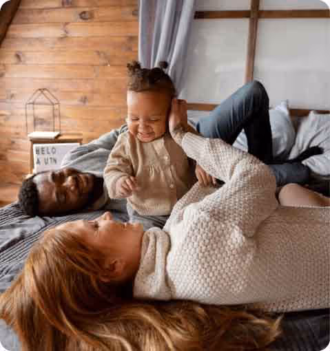 A woman and a child laying on a bed.