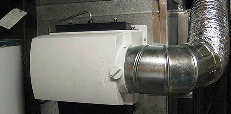 Whole-house humidifier connected to HVAC duct.