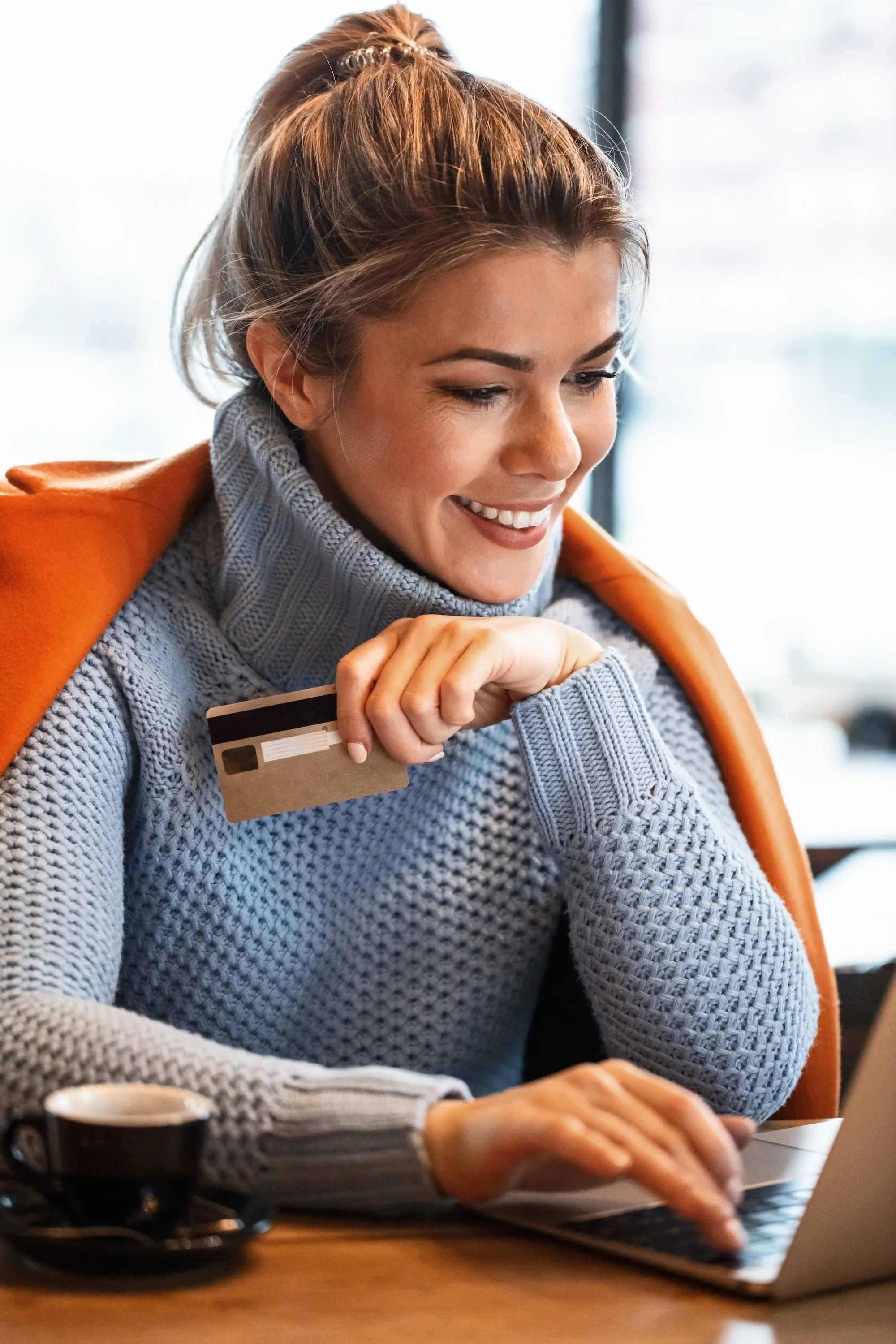 Happy woman looking at laptop