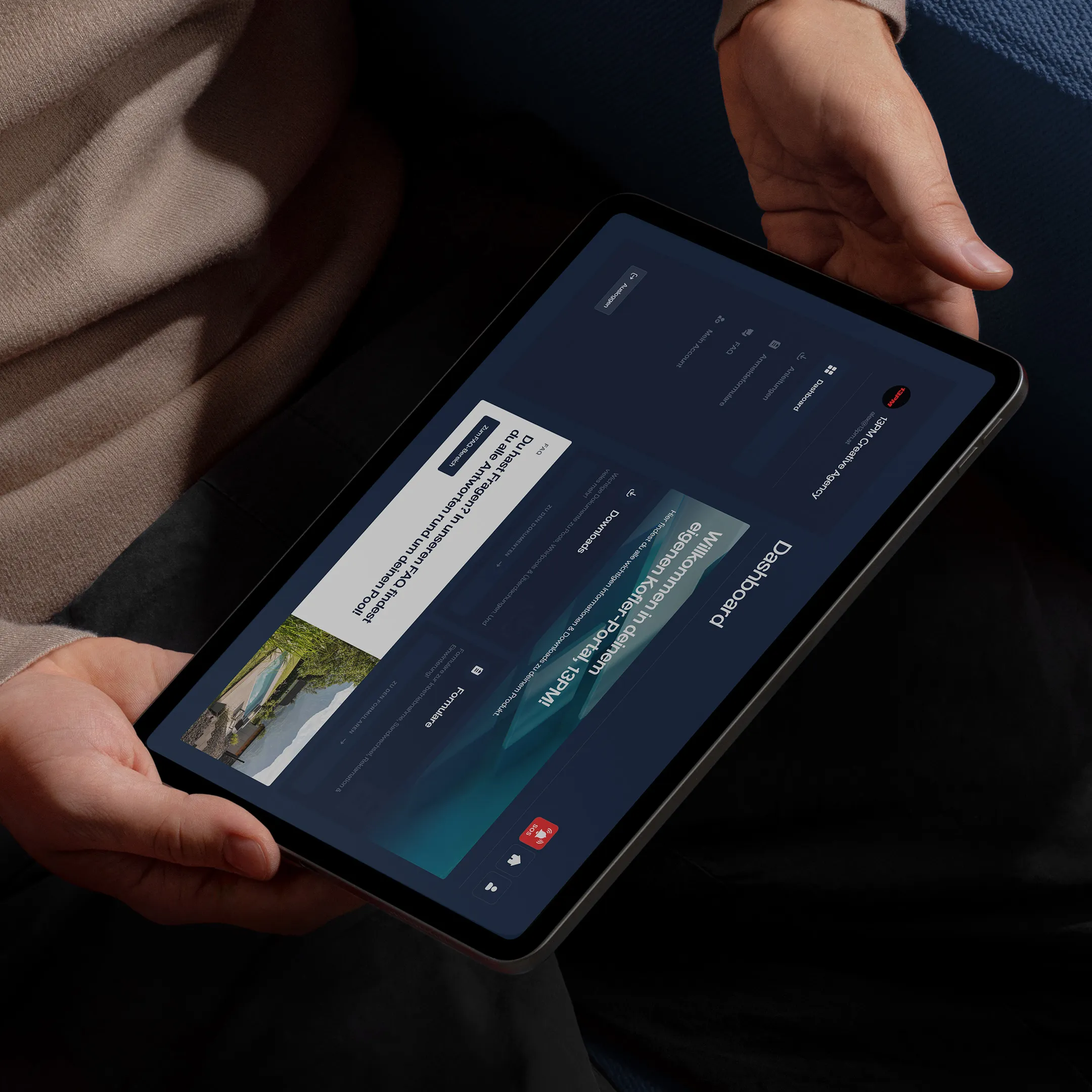 Mann auf einer blauen Couch mit einem Tablet, sieht sich das Kofler Dashboard an