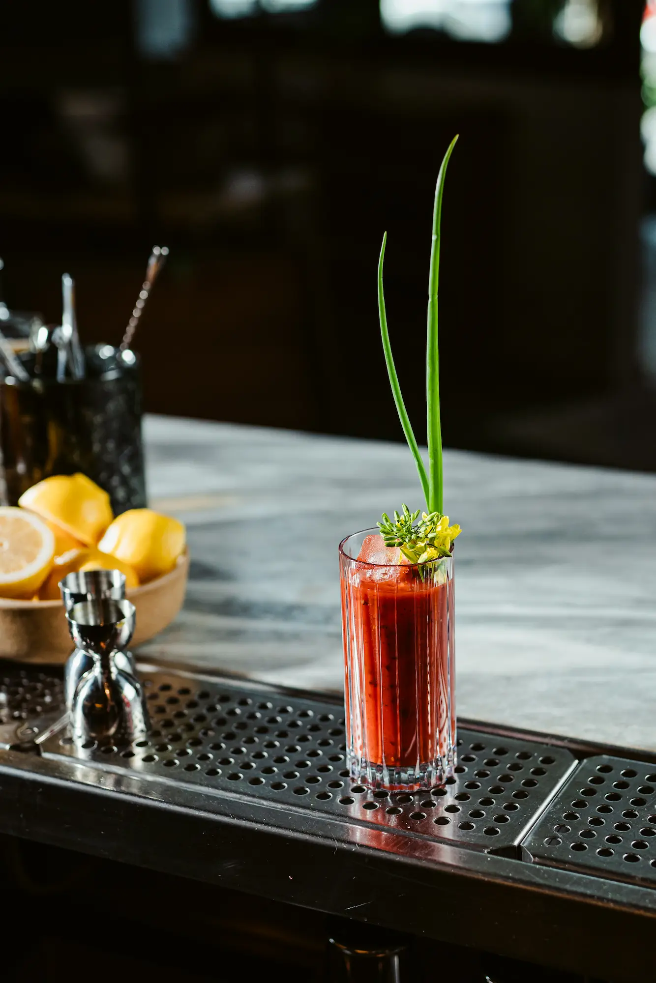 A craft bloody mary in Bold Drinkware Tryst Hi Ball on a marble bartop